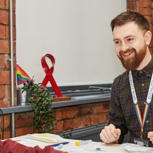 LGBT Foundation employee talking to a service user, preparing for a full-screening test.