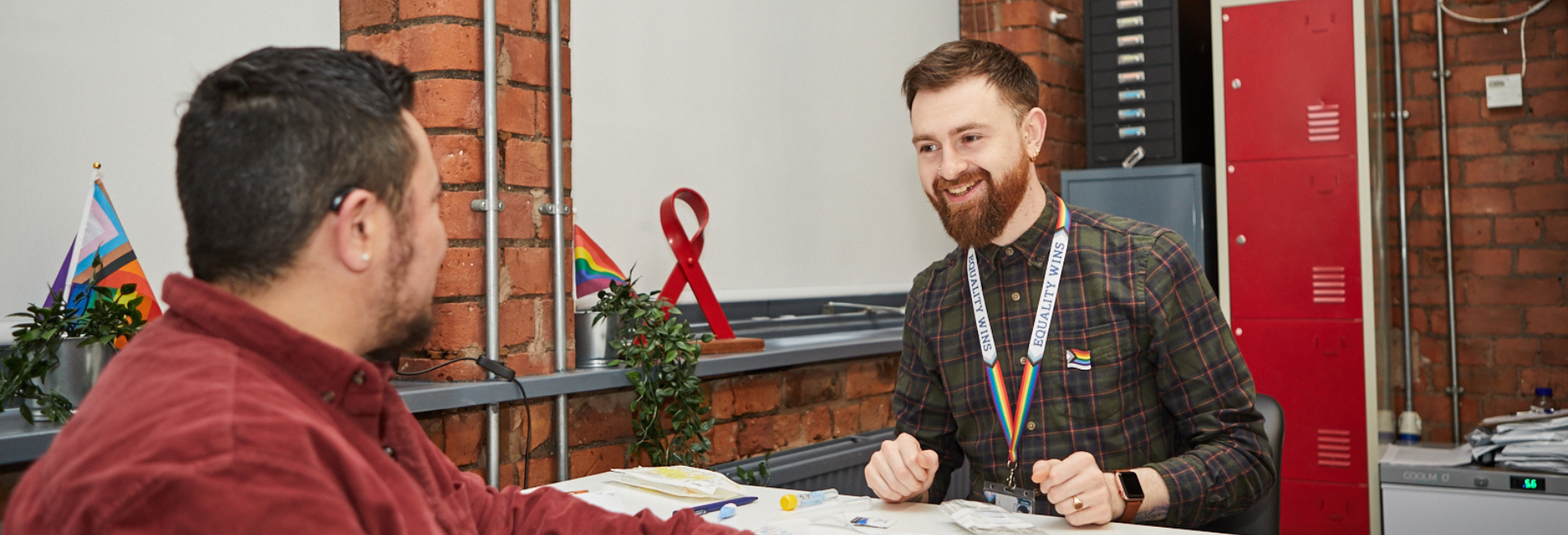 A sexual health advisor is talking to a man in the sexual health clinic at LGBT Foundation.