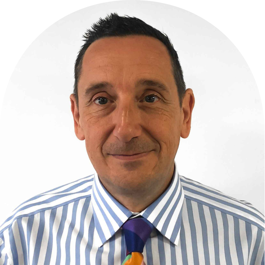 man in striped shirt and tie smiling at camera. Portrait.