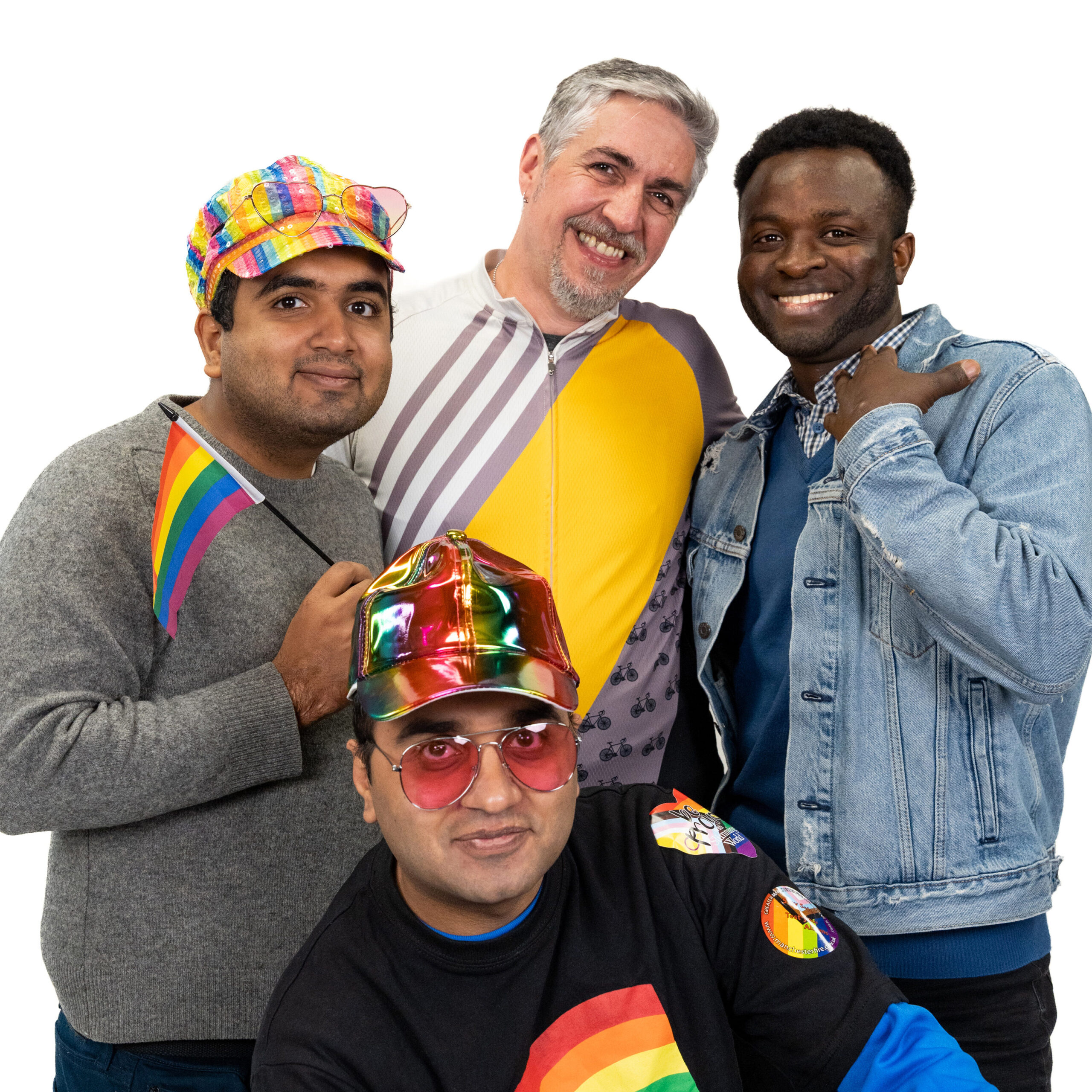 A group of LGBTQ+ men smiling and looking at the camera against a white backdrop for LGBT Foundation's Man Enough campaign