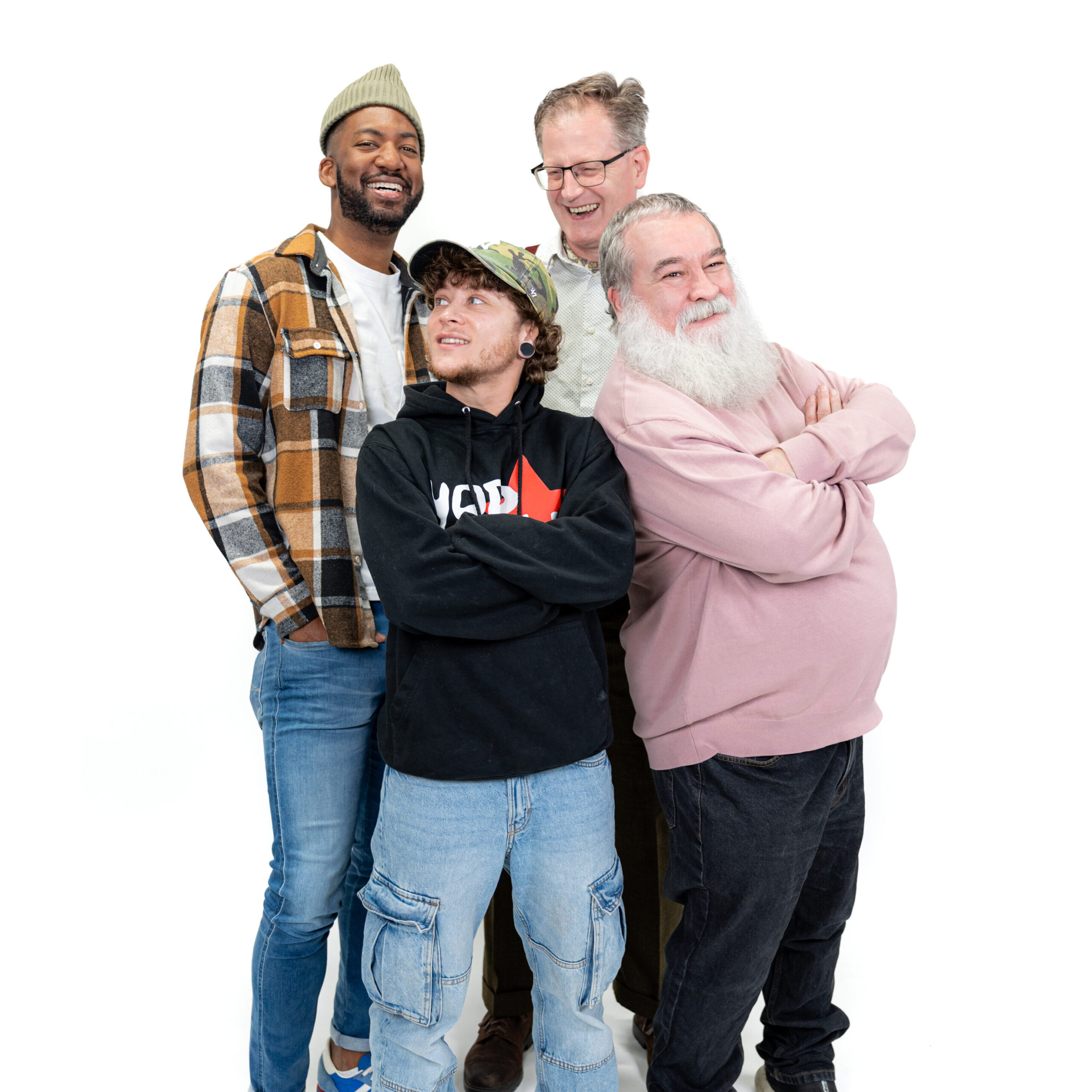 A group of four LGBTQ+ men smiling back-to-back against a white backdrop for LGBT Foundation's Man Enough campaign