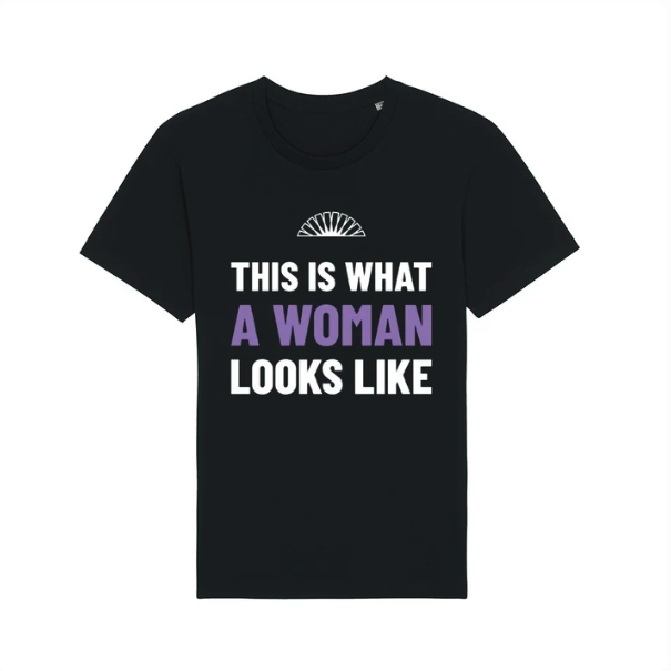 A black t-shirt with the slogan "This is What a Woman Looks Like" across the front, with "A Woman" in purple and the rest in white text.