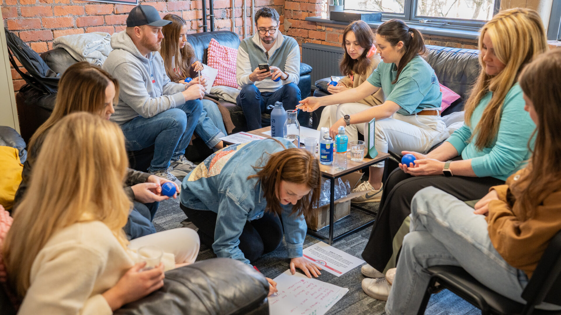 A group of corporate volunteers talking, discussing and brainstorming together in LGBT Foundation's centre.
