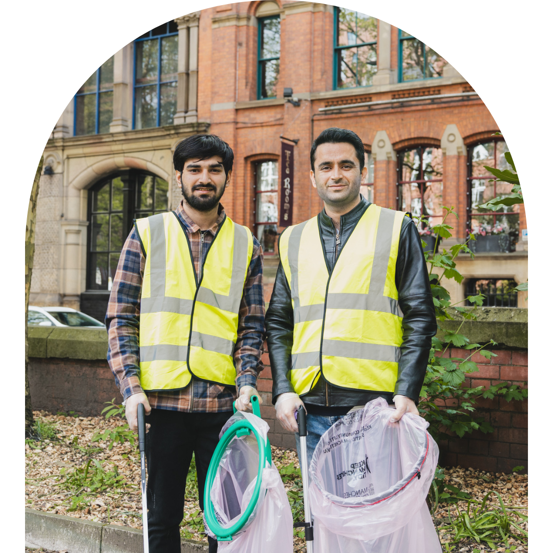 Arch frame photo of two LGBT Foundation volunteers in neon vests.