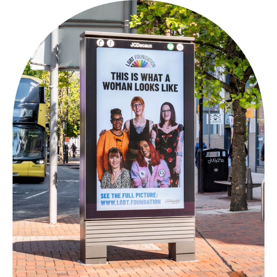 Arch frame photo of a billboard from LGBT Foundation's 'This Is What A Woman Looks Like' campaign.